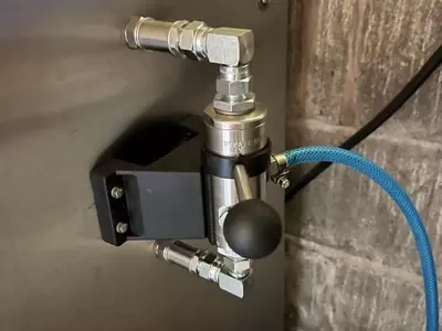 External chemical injector fitted onto the side of a Nilfisk Truck Booster for a farm installation in Ellistown. This modification improved detergent application and cleaning performance for regular agricultural washdown work.